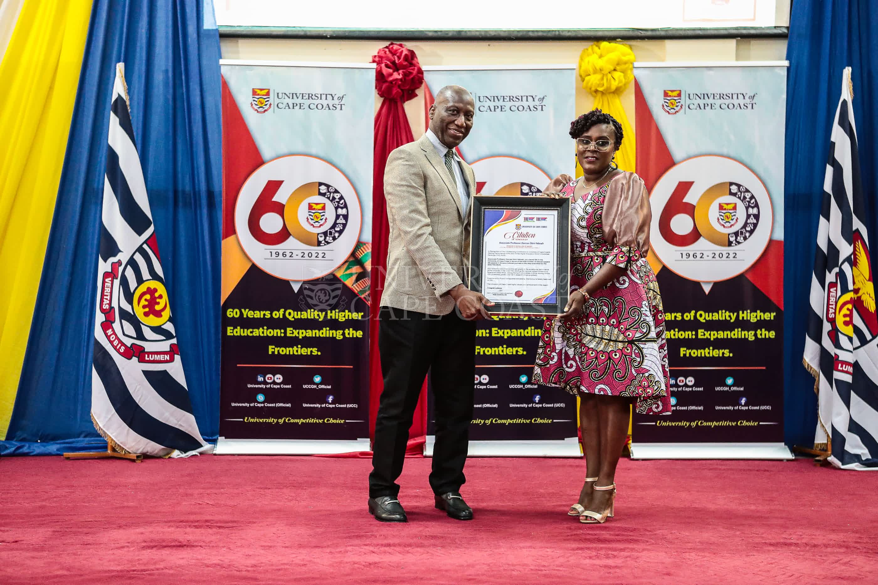 Registrar of UCC presenting an award to Prof. Dorcas Obiri-Yeboah, an awardee.